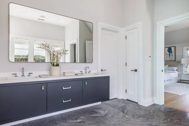 a bathroom with a double vanity sink and mirror