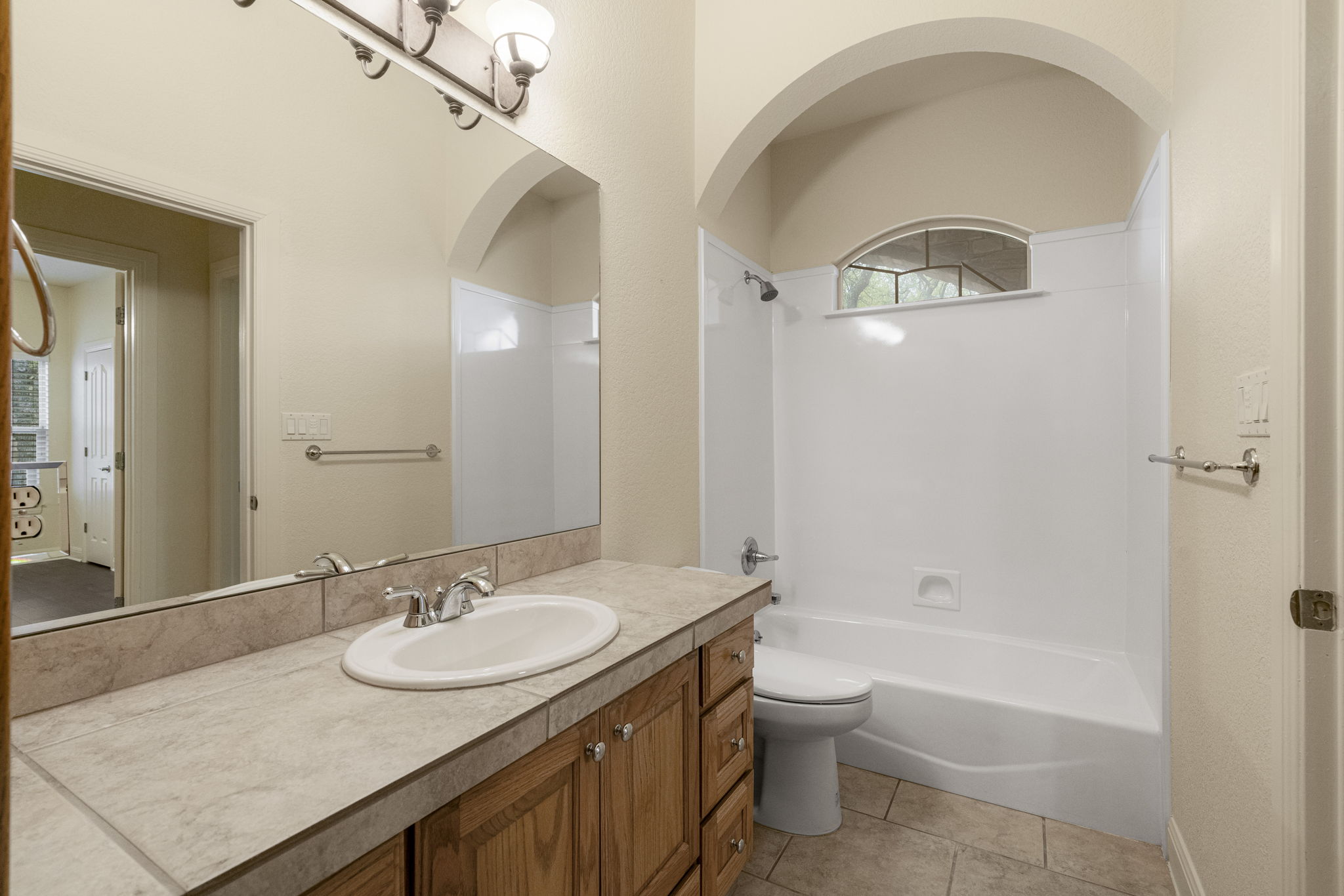 301 Goldridge Drive Georgetown, TX 78633 - Photo 28 of 40 a bathroom with a granite countertop sink a toilet and shower