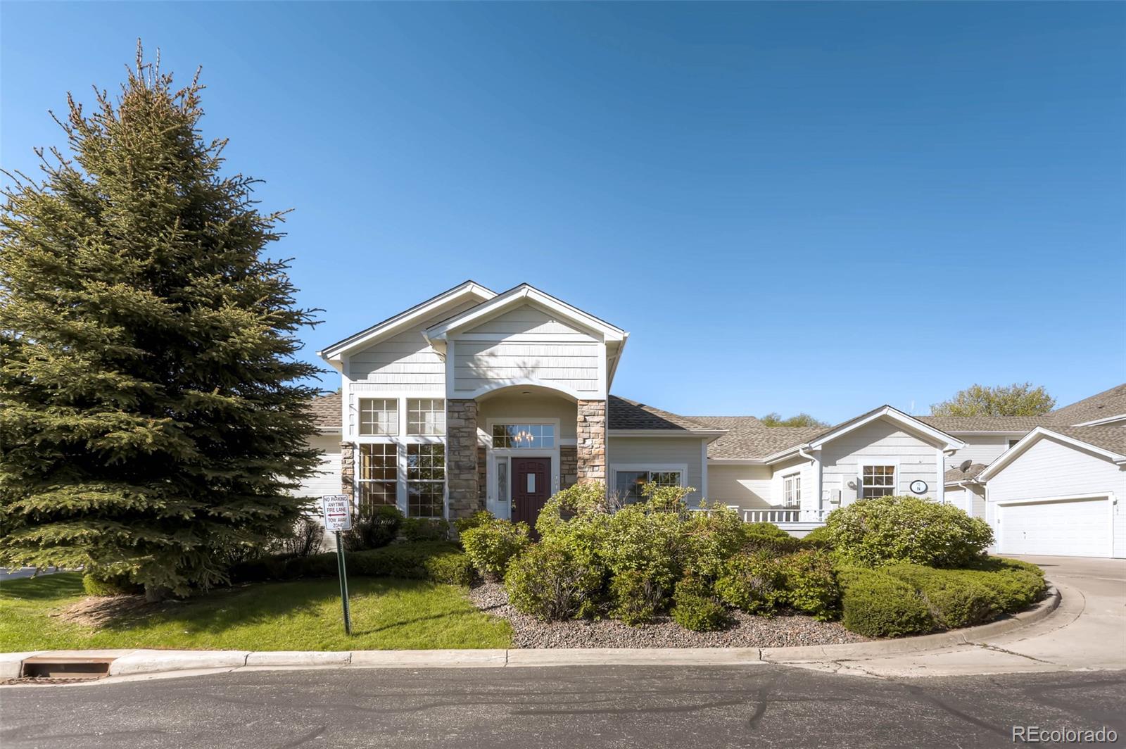 8300 Fairmount Drive, Unit N101 Denver, CO 80247 - Photo 1 of 27 a front view of a house with a garden
