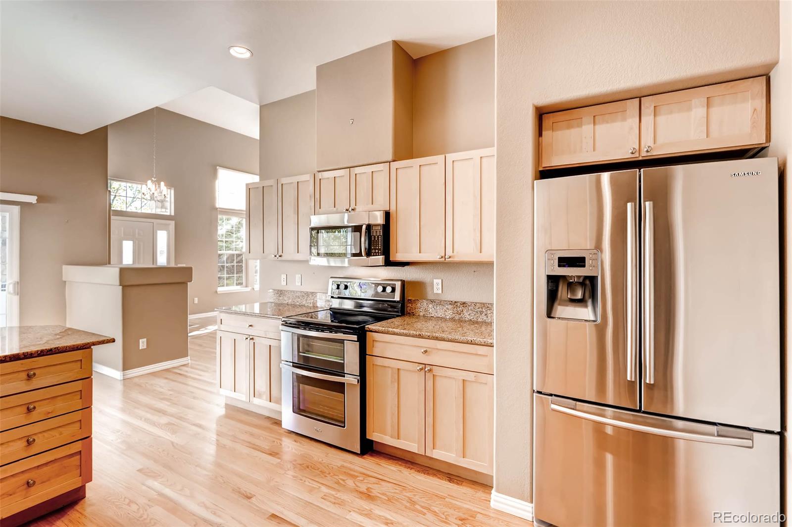 8300 Fairmount Drive, Unit N101 Denver, CO 80247 - Photo 11 of 27 a kitchen with stainless steel appliances a refrigerator sink and microwave