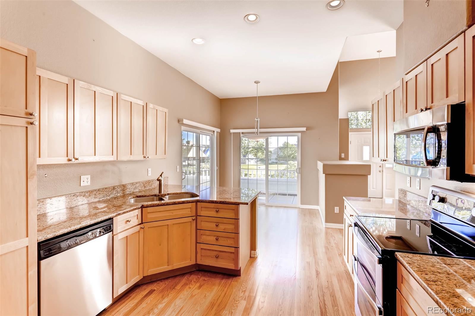 8300 Fairmount Drive, Unit N101 Denver, CO 80247 - Photo 12 of 27 a kitchen with stainless steel appliances a stove sink and cabinets