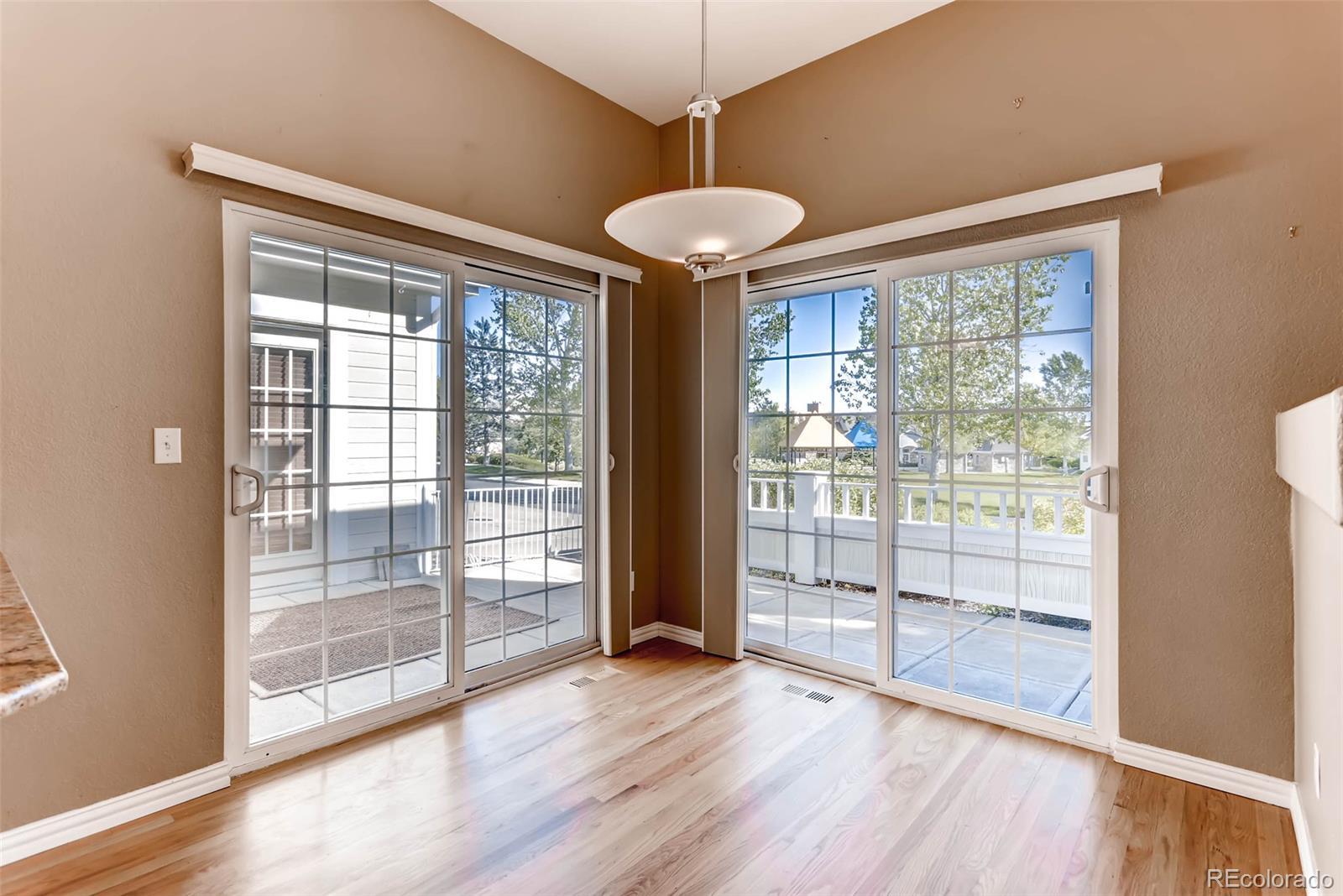 8300 Fairmount Drive, Unit N101 Denver, CO 80247 - Photo 13 of 27 a view of a room with wooden floor and windows