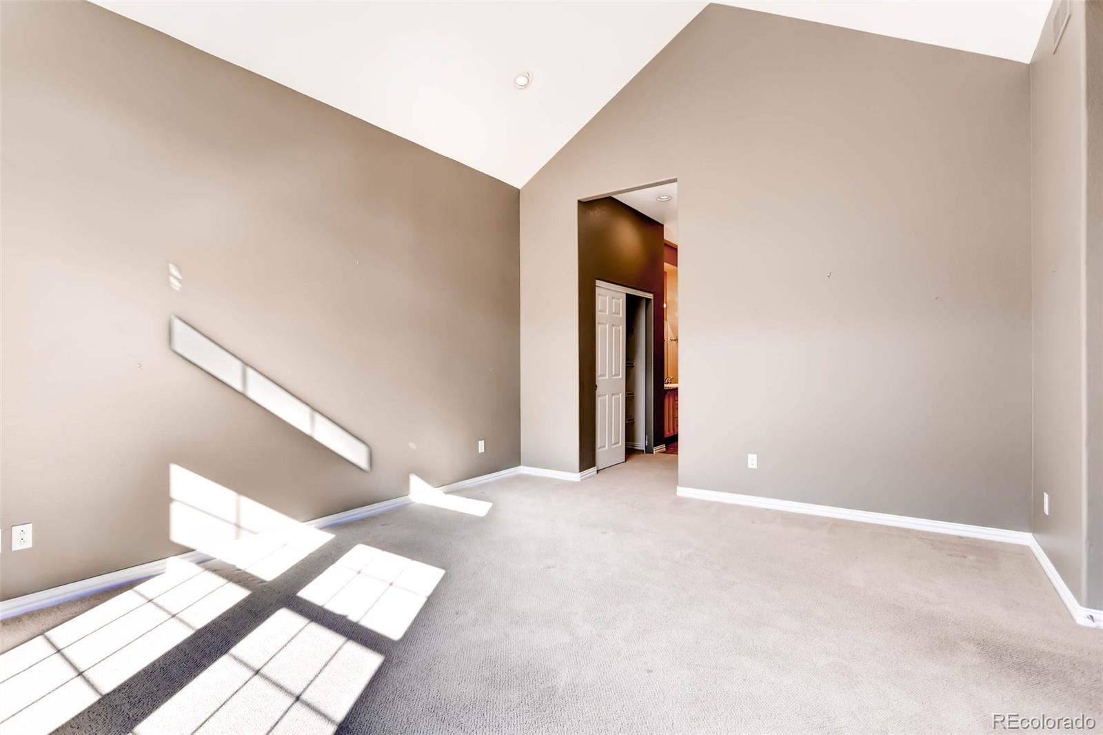 8300 Fairmount Drive, Unit N101 Denver, CO 80247 - Photo 16 of 27 a view of an empty room with wooden floor and a window