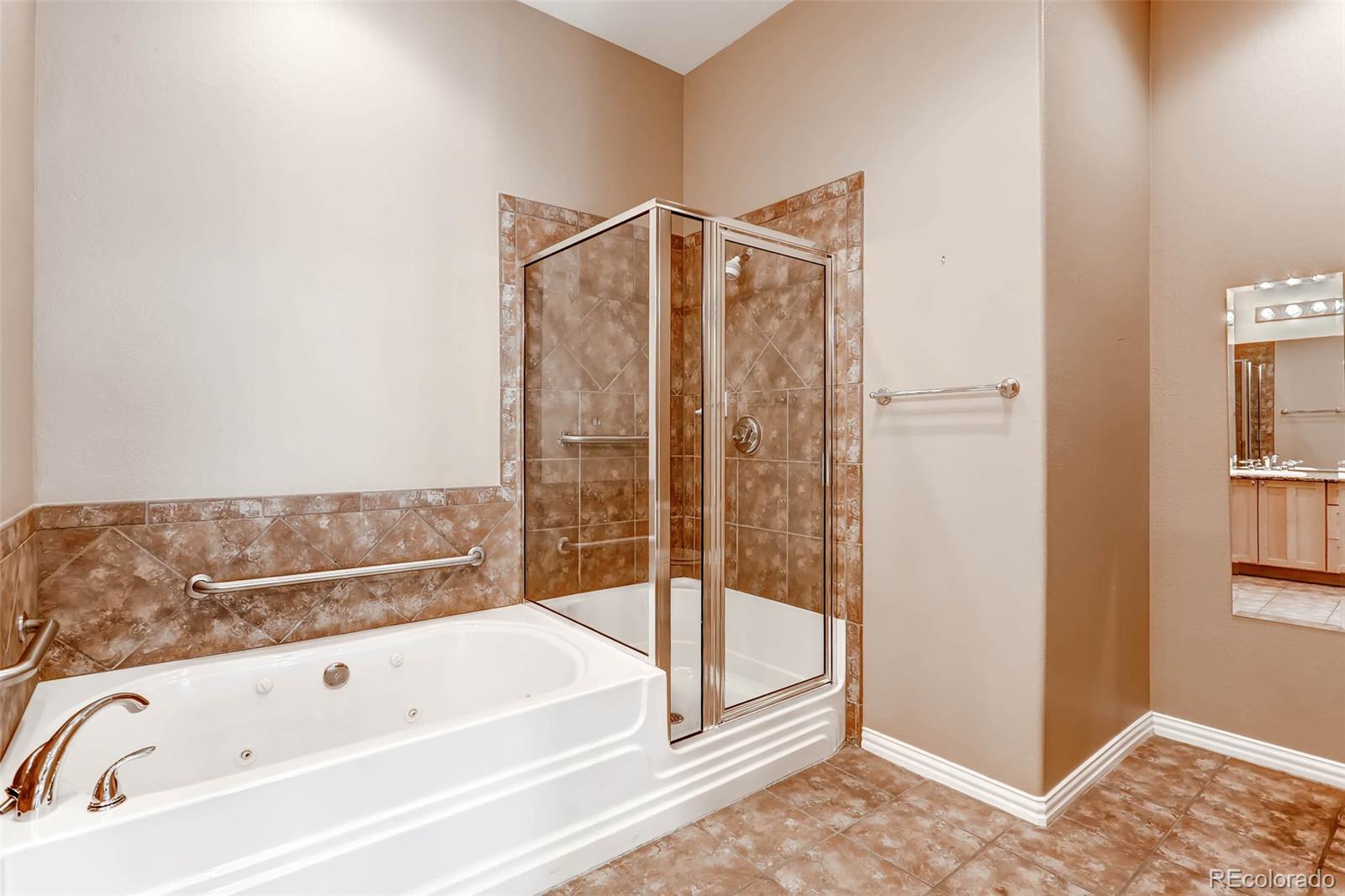 8300 Fairmount Drive, Unit N101 Denver, CO 80247 - Photo 17 of 27 a bathroom with a bathtub and a shower