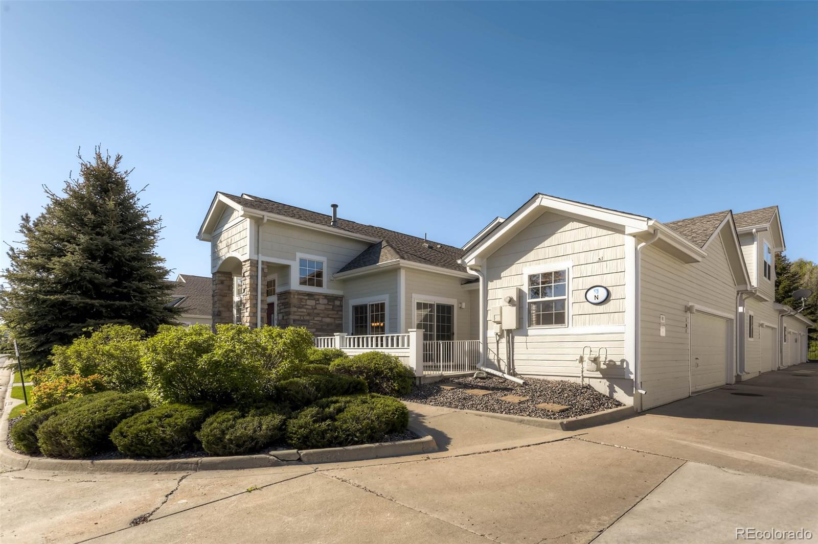 8300 Fairmount Drive, Unit N101 Denver, CO 80247 - Photo 2 of 27 a front view of a house with a yard