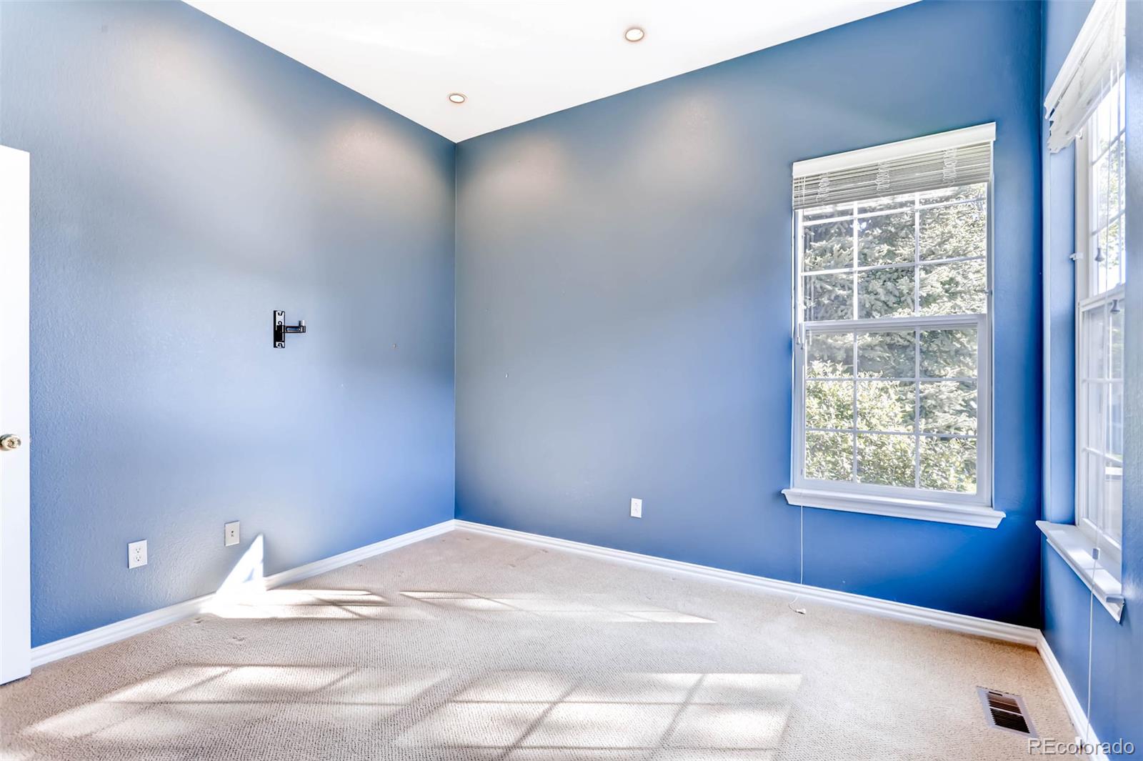 8300 Fairmount Drive, Unit N101 Denver, CO 80247 - Photo 21 of 27 a bedroom with a bed and a window