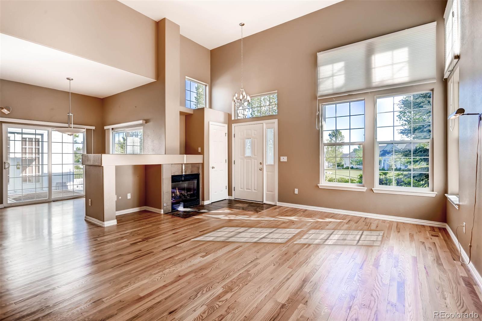 8300 Fairmount Drive, Unit N101 Denver, CO 80247 - Photo 3 of 27 a view of empty room with wooden floor and fireplace
