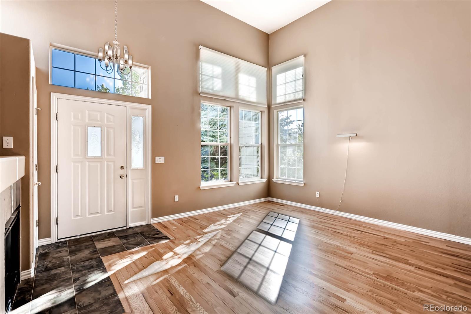 8300 Fairmount Drive, Unit N101 Denver, CO 80247 - Photo 6 of 27 a view of an empty room with wooden floor and a window