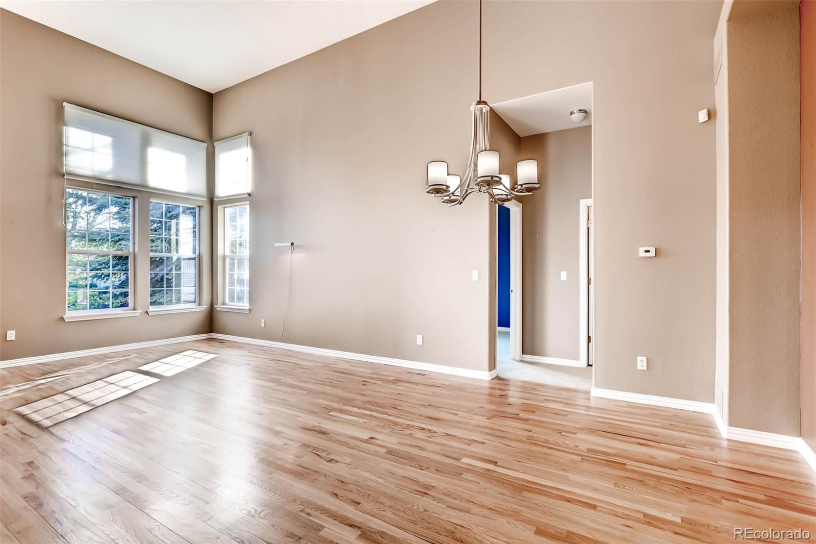 8300 Fairmount Drive, Unit N101 Denver, CO 80247 - Photo 8 of 27 a view of a livingroom with wooden floor and a large window