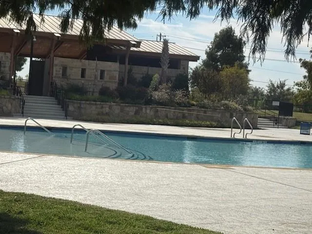 a view of swimming pool with a yard