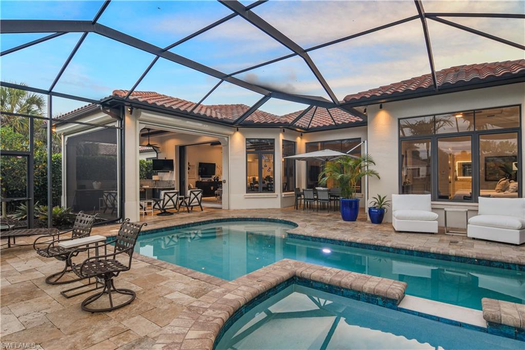 2220 Residence Circle Naples, FL 34105 - Photo 29 of 50 a swimming pool with outdoor seating and yard