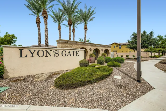 a patio with table and chairs and potted plants
