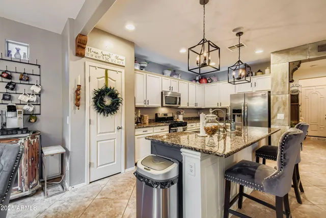 a dining room with furniture a chandelier and wooden floor
