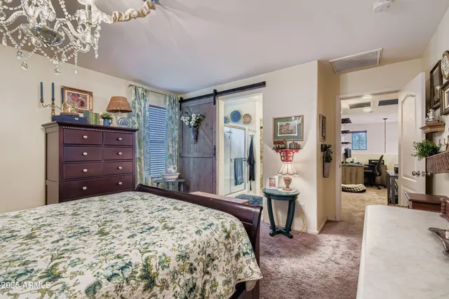 a living room with furniture a lamp and a chandelier