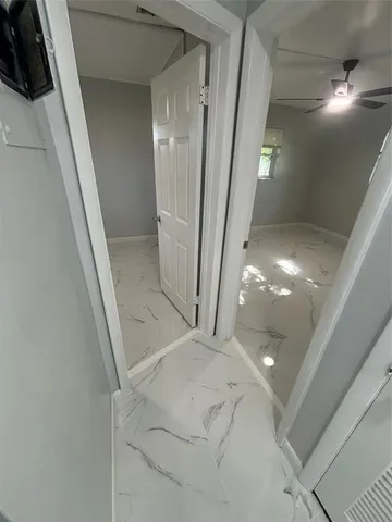 a view of staircase with white walls and railing