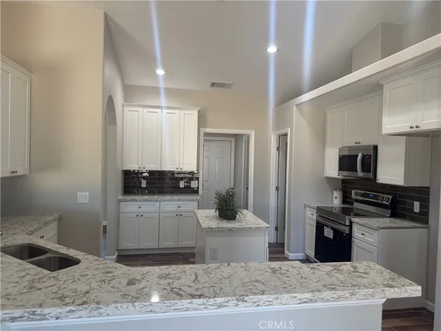 a kitchen with a sink and a stove top oven