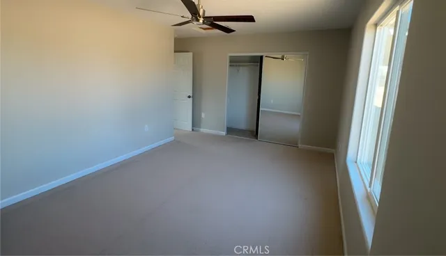 a bathroom with a granite countertop toilet a sink and a mirror