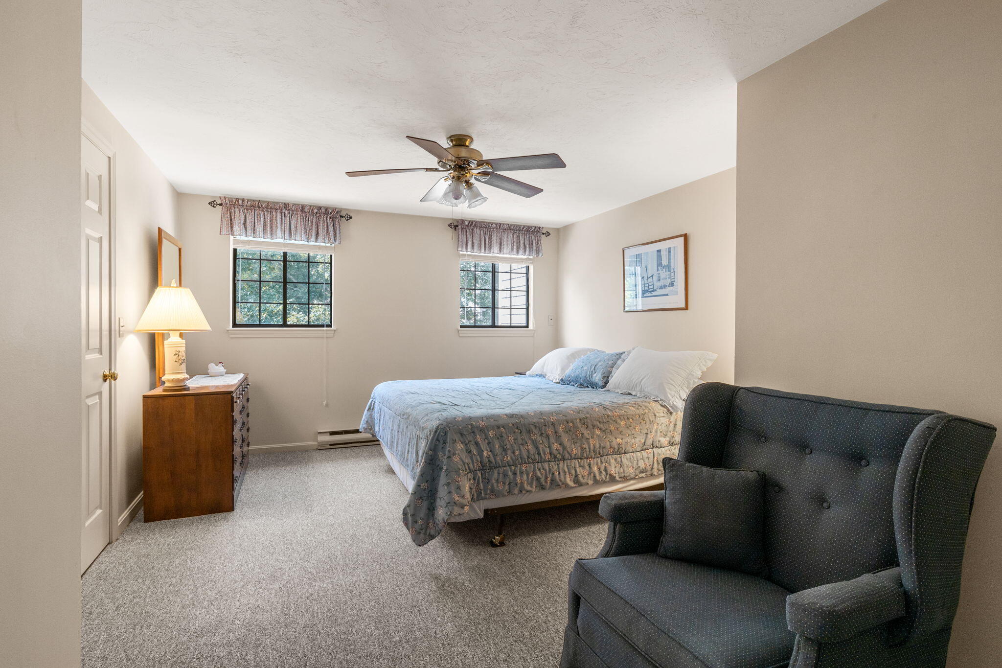 45 West Road, Unit 1E Orleans, MA 02653 - Photo 17 of 37 a spacious bedroom with a bed and a couch