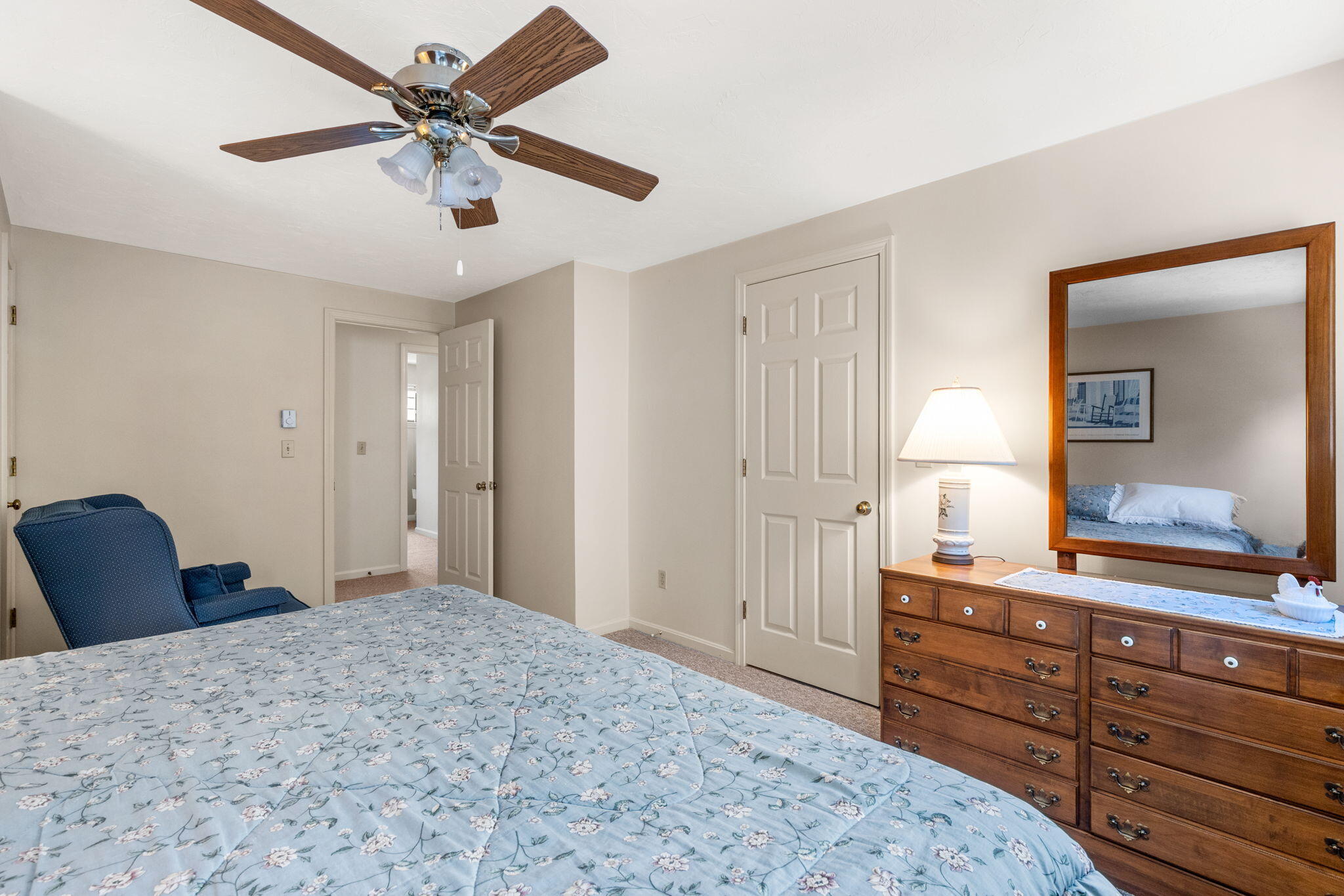 45 West Road, Unit 1E Orleans, MA 02653 - Photo 18 of 37 a bedroom with a bed and a mirror on dresser
