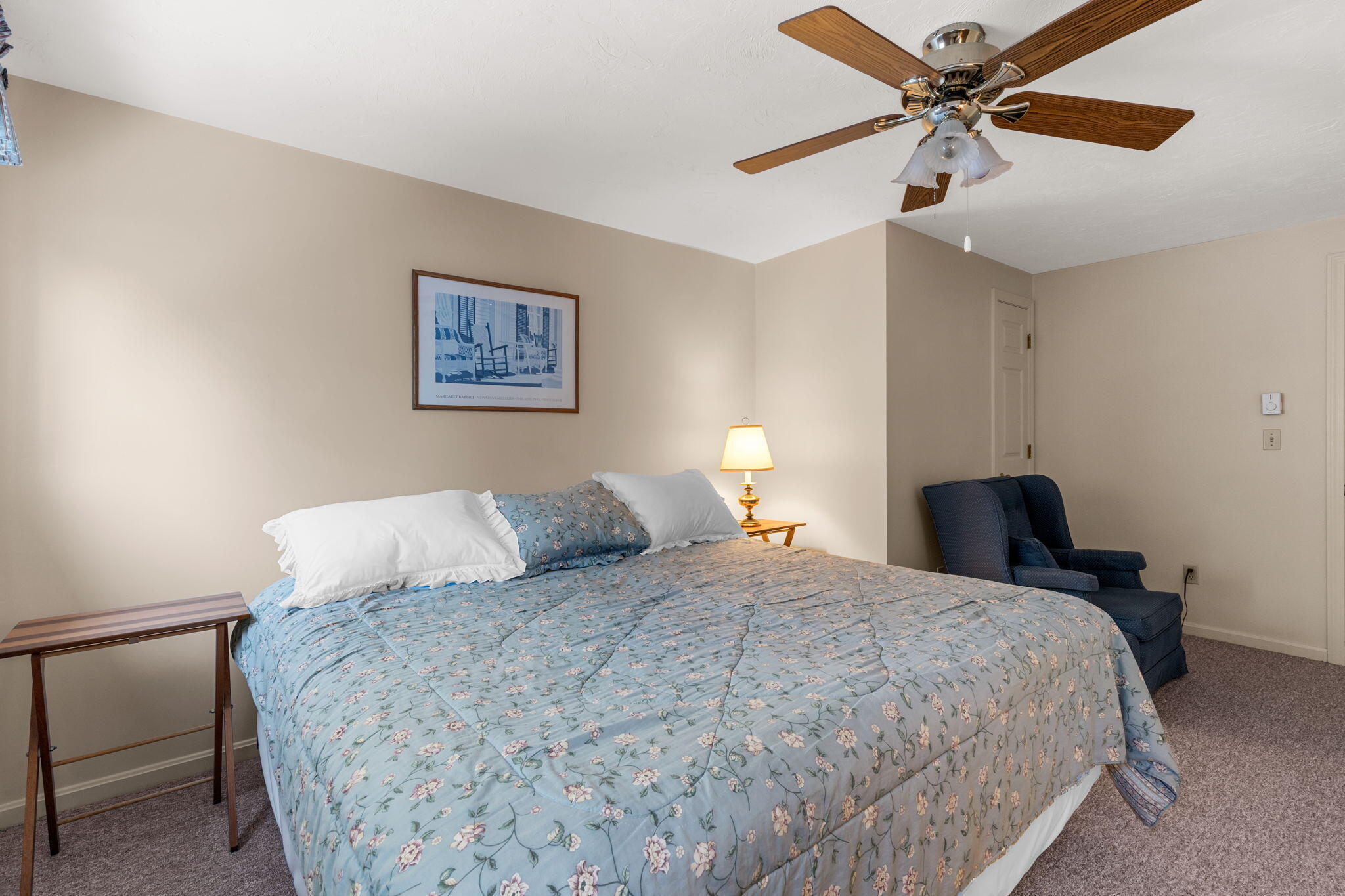 45 West Road, Unit 1E Orleans, MA 02653 - Photo 19 of 37 a bedroom with a bed and a chandelier