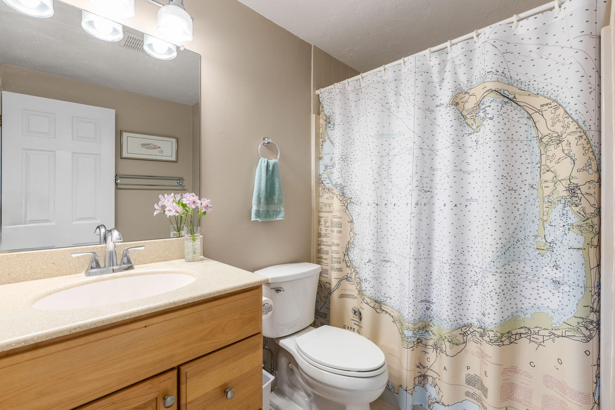 45 West Road, Unit 1E Orleans, MA 02653 - Photo 20 of 37 a bathroom with a sink a toilet and shower curtain