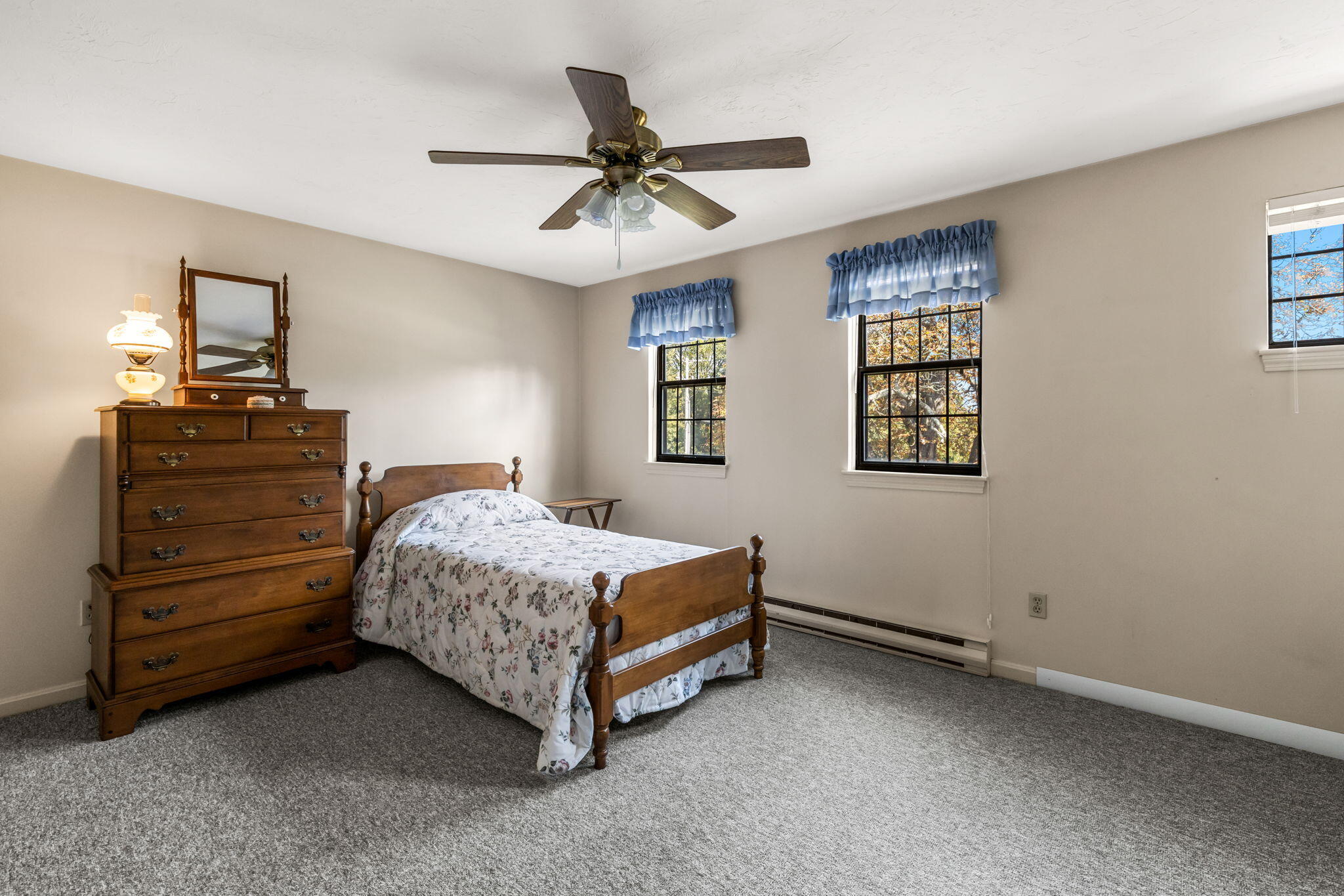 45 West Road, Unit 1E Orleans, MA 02653 - Photo 22 of 37 a bedroom with a bed and a chandelier