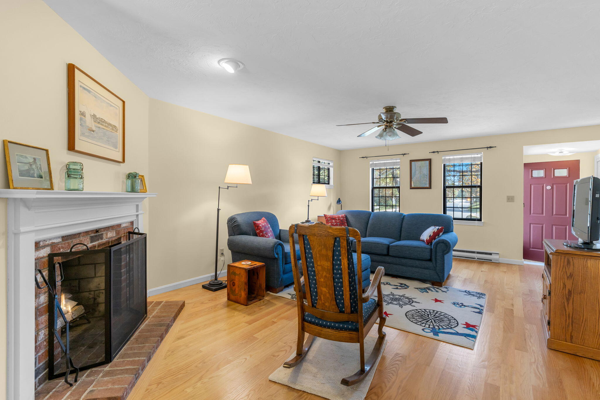 45 West Road, Unit 1E Orleans, MA 02653 - Photo 6 of 37 a living room with furniture fireplace and wooden floor