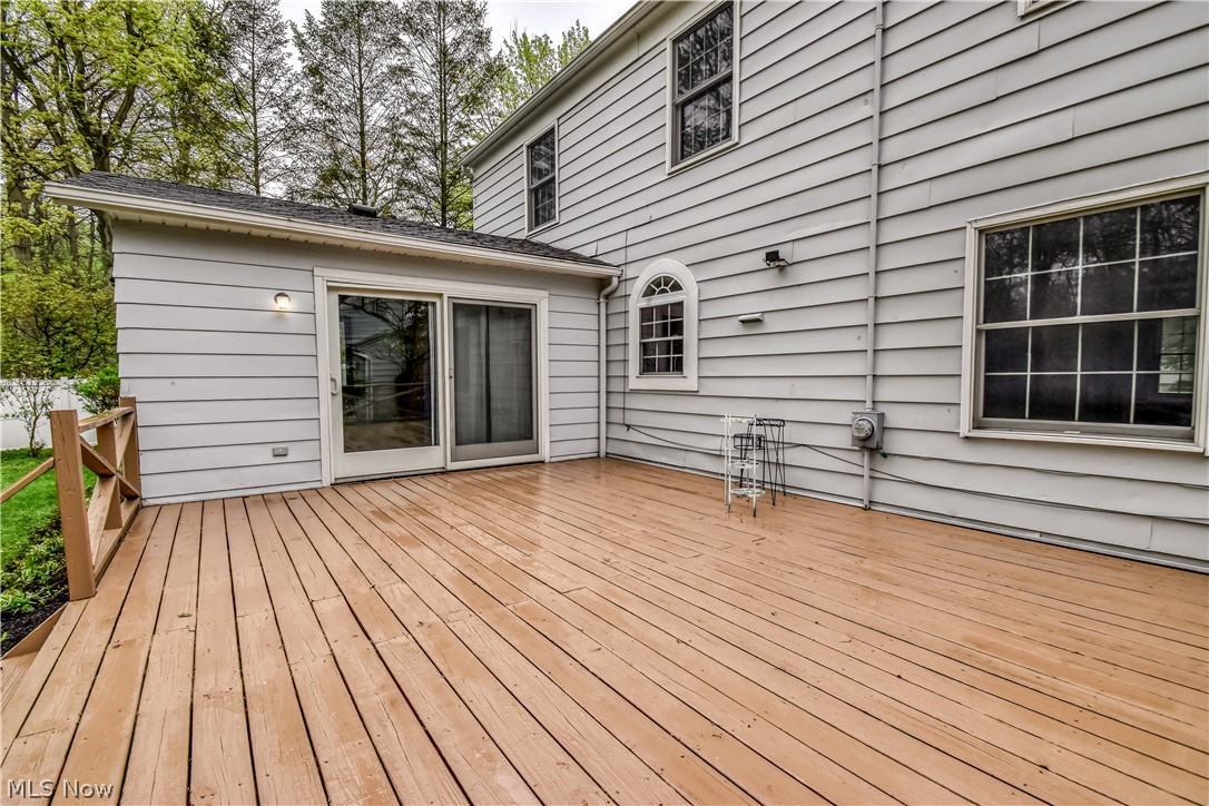 8242 Starburst Road Mentor, OH 44060 - Photo 21 of 37 Expansive wood-finish deck with a wood railing, offering exterior access via sliding glass doors