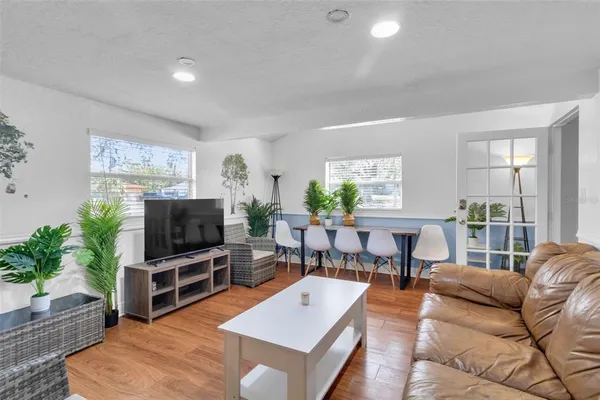 a living room with furniture and wooden floor
