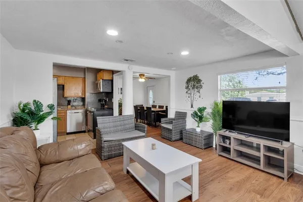 a living room with furniture and a potted plant