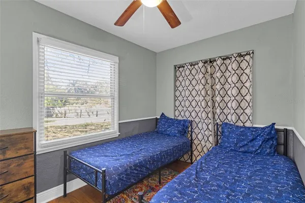 a bedroom with a bed and a desk