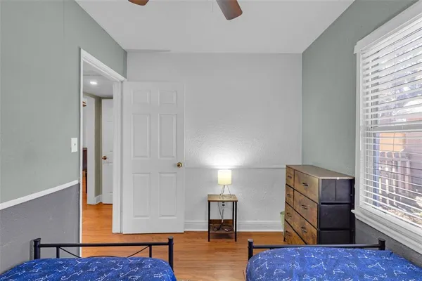 a bedroom with two beds and a chandelier