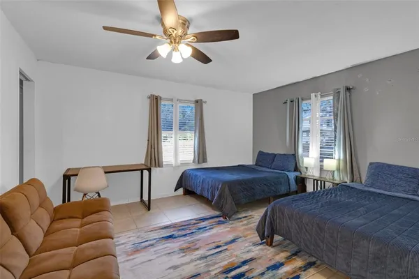 a bedroom with two beds and a chandelier