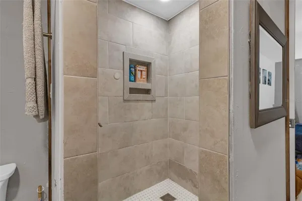 a living room with furniture and a baby crib