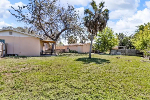 a wooden bench sitting in the backyard of a house