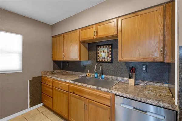 a kitchen with a sink and stainless steel appliances