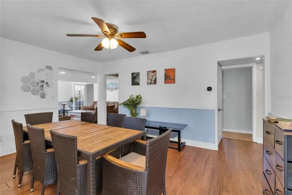 a view of a dining room with furniture and a potted plant