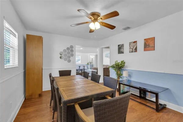 a view of a dining room with furniture window and wooden floor
