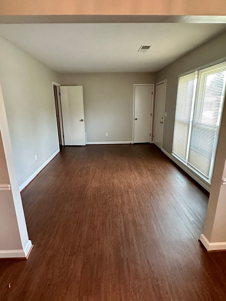 116 Whippoorwill Lane Columbus, GA 31906 - Photo 4 of 13 an empty room with wooden floor and windows