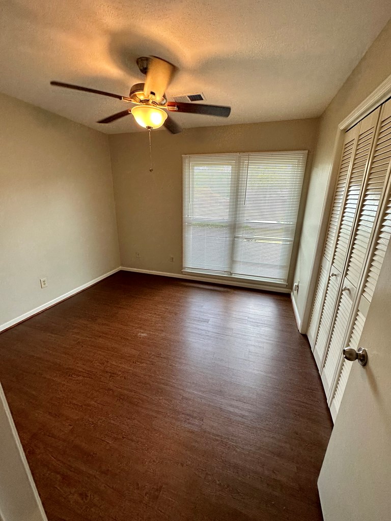 116 Whippoorwill Lane Columbus, GA 31906 - Photo 10 of 13 wooden floor in an empty room with a window