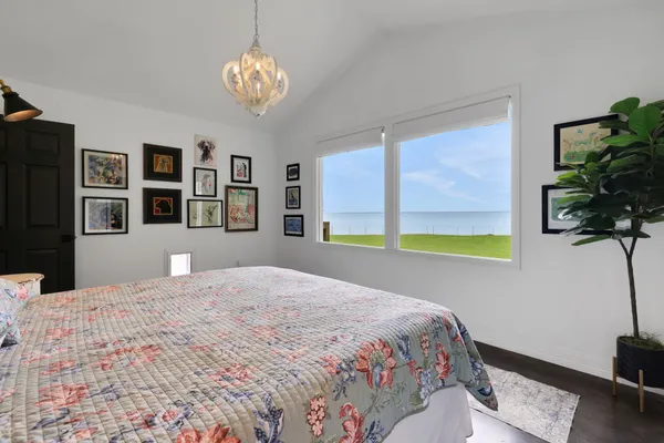a bedroom with a bed and a potted plant