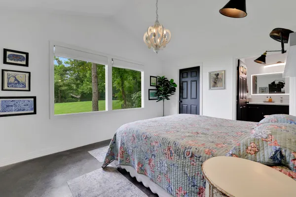 a bedroom with a bed and a chandelier