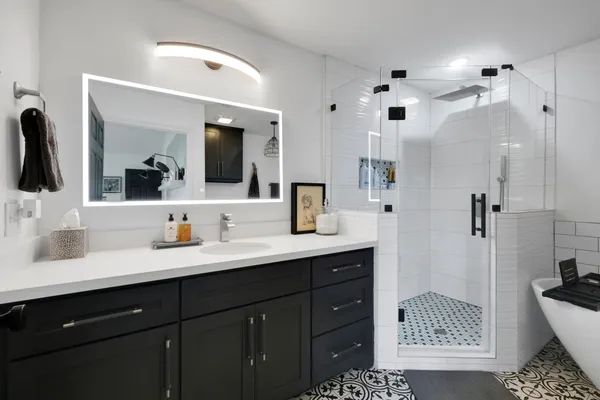 a bathroom with a sink a toilet and shower