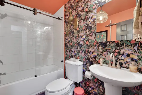 a bathroom with a sink toilet and shower