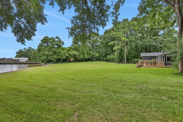 a view of a house with a yard and sitting area