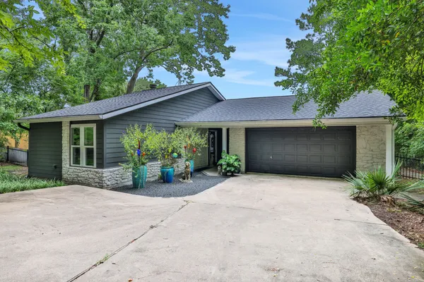 a front view of a house with garden and porch