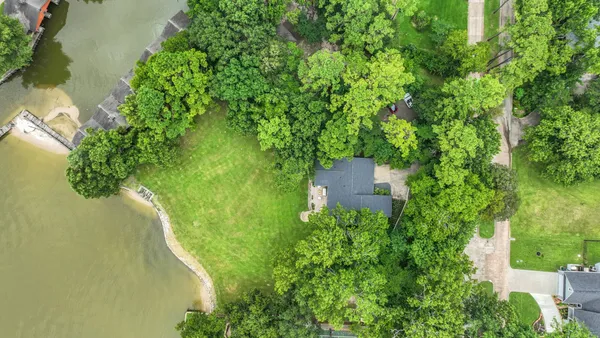 an aerial view of residential house with an outdoor space and seating