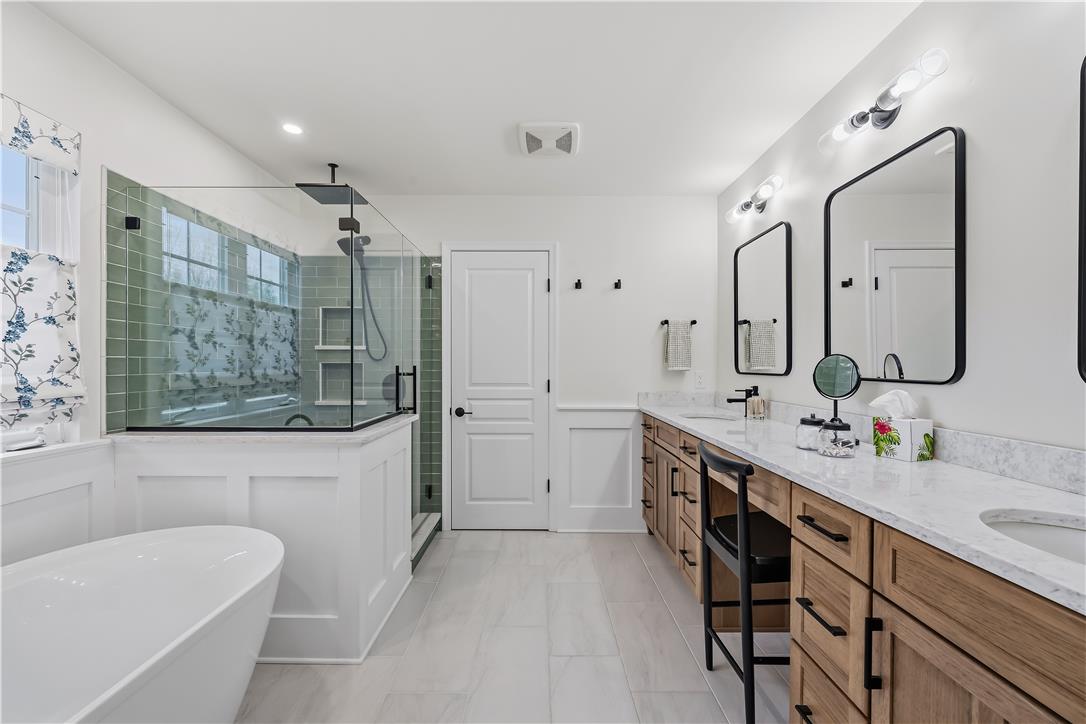 9031 Pathfinder Road Breinigsville, PA 18031 - Photo 33 of 63 Luxurious bathing space showcasing a spacious walk-in shower and elegant double vanity.