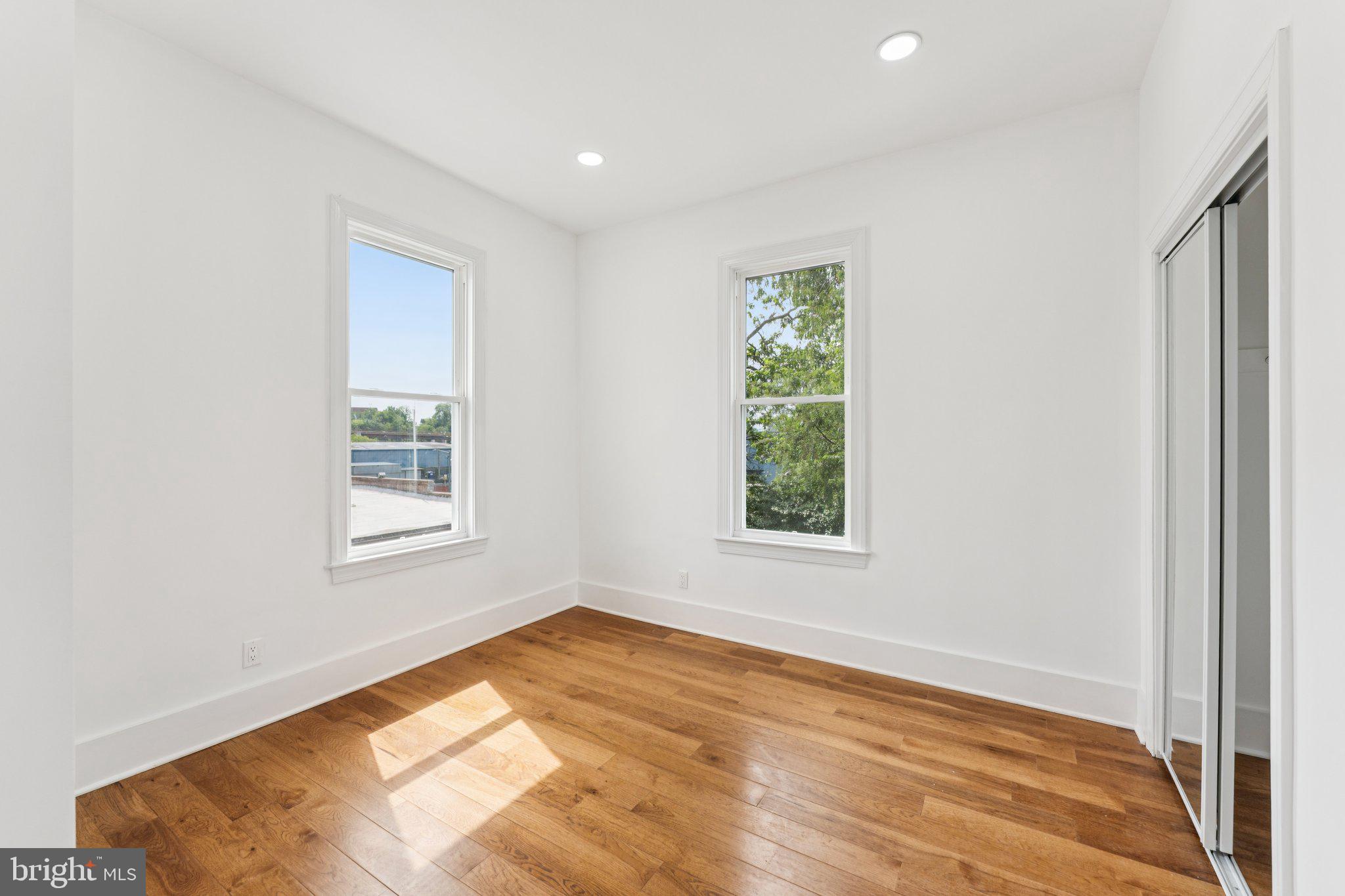 2105 4th Street Northeast Washington, DC 20002 - Photo 20 of 30 an empty room with wooden floor and windows