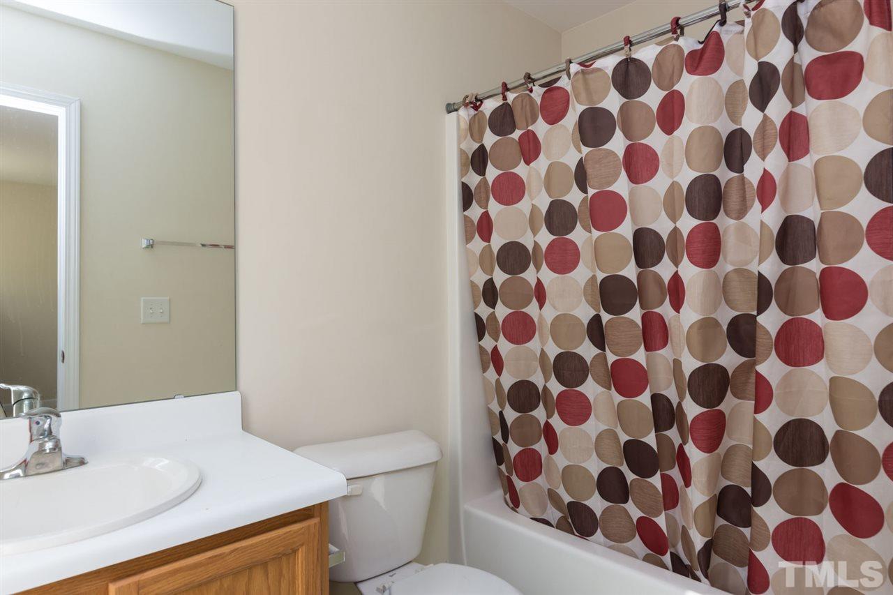 3515 Oneonta Avenue Raleigh, NC 27604 - Photo 11 of 13 a bathroom with a sink toilet and mirror
